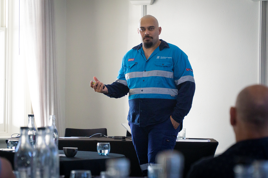 Lachie standing in front of a group of people, teaching